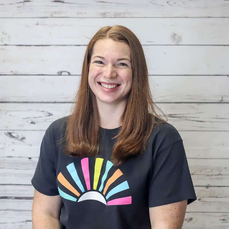 Abby Quatmann headshot photo with white wood background