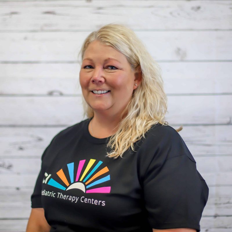 dawn hergenrother headshot photo with white wood background