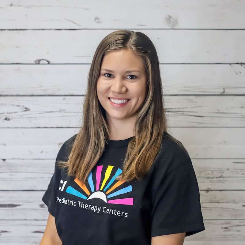 Maria_Romero 2022 headshot photo with white wood background.
