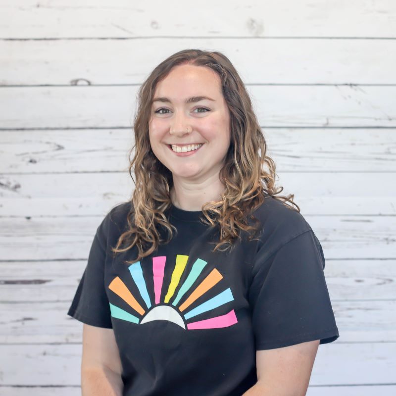 Rachel Triller headshot photo with white wood background